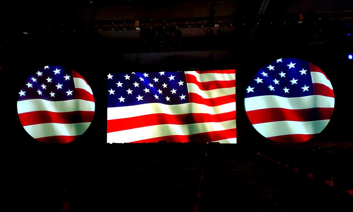 American flag projected on projection screens on big stage