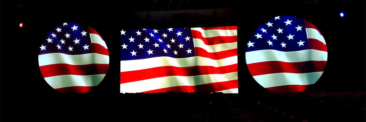 The American flag projected onto a Borderless Projection Screen flanked by two Full Moons