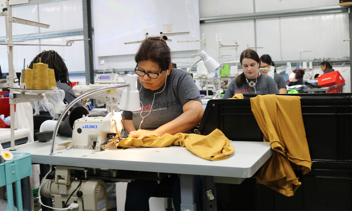 Our dedicated production team hard at work sewing fabric